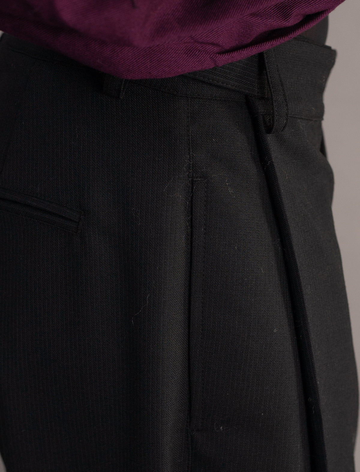 Close-up of dark grey pinstripe pants