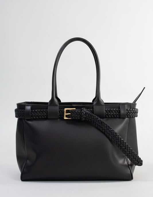 Black handbag with braided handle on a grey background