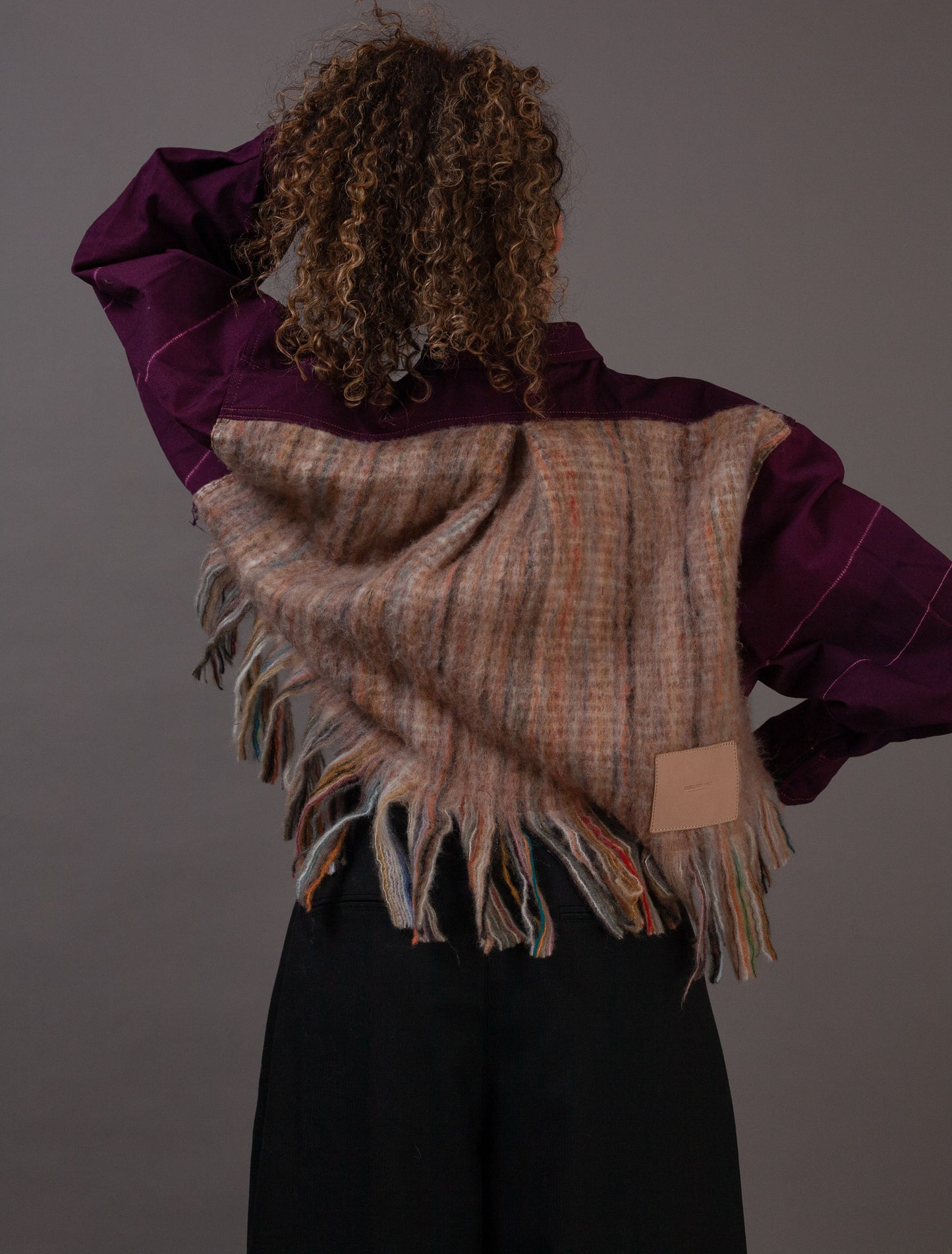 Person wearing a purple jacket with wool blanket back