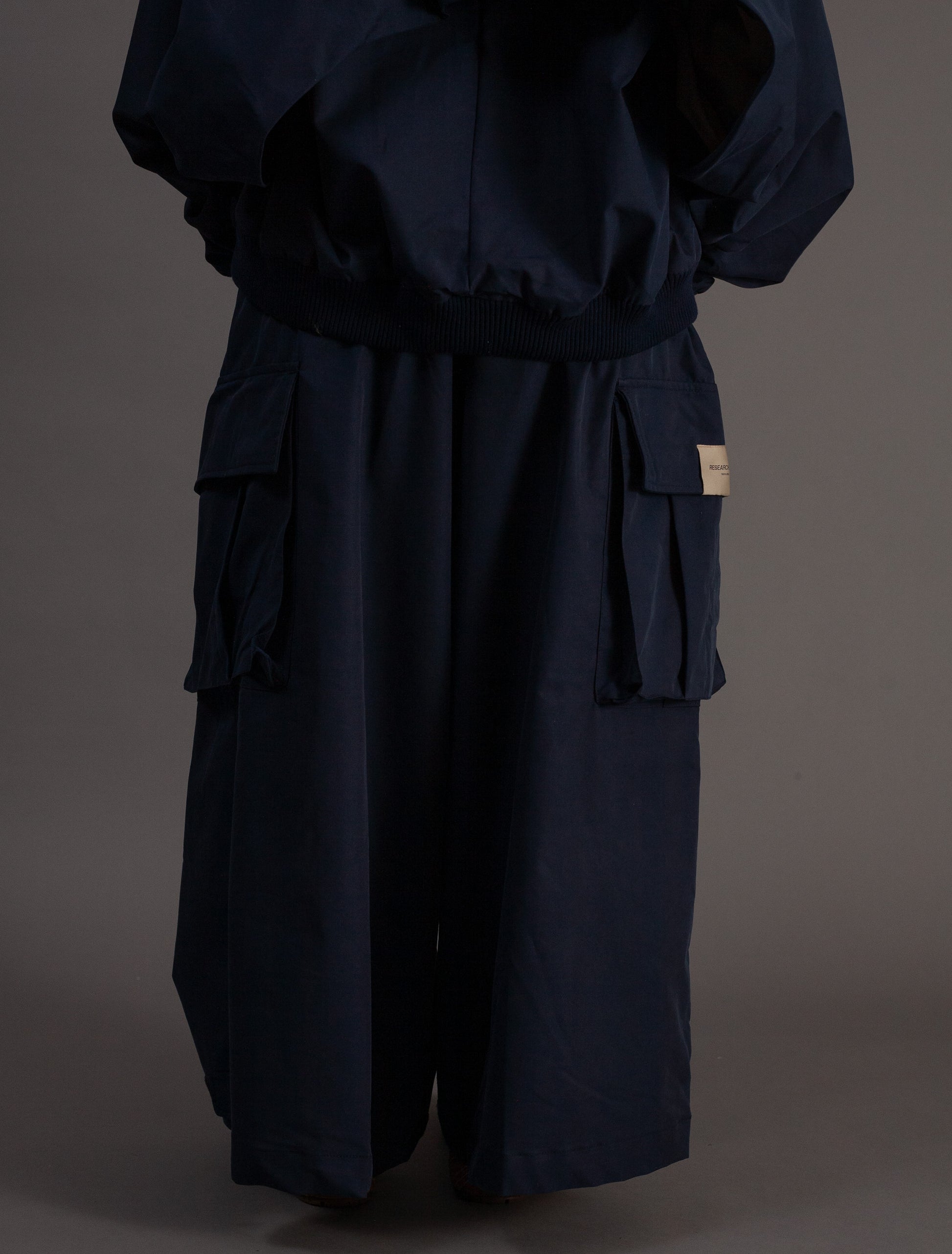 Navy blue outfit with wide-leg pants on a dark background