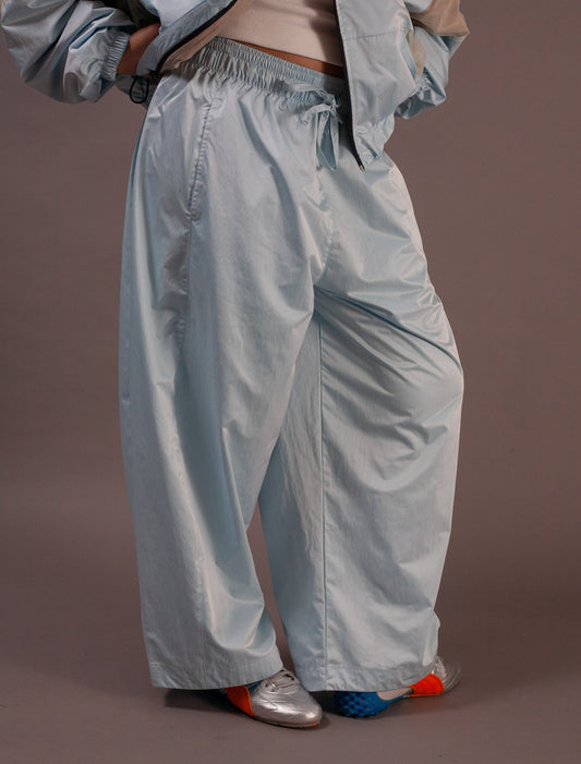 Light blue pants worn by a person on a brown background