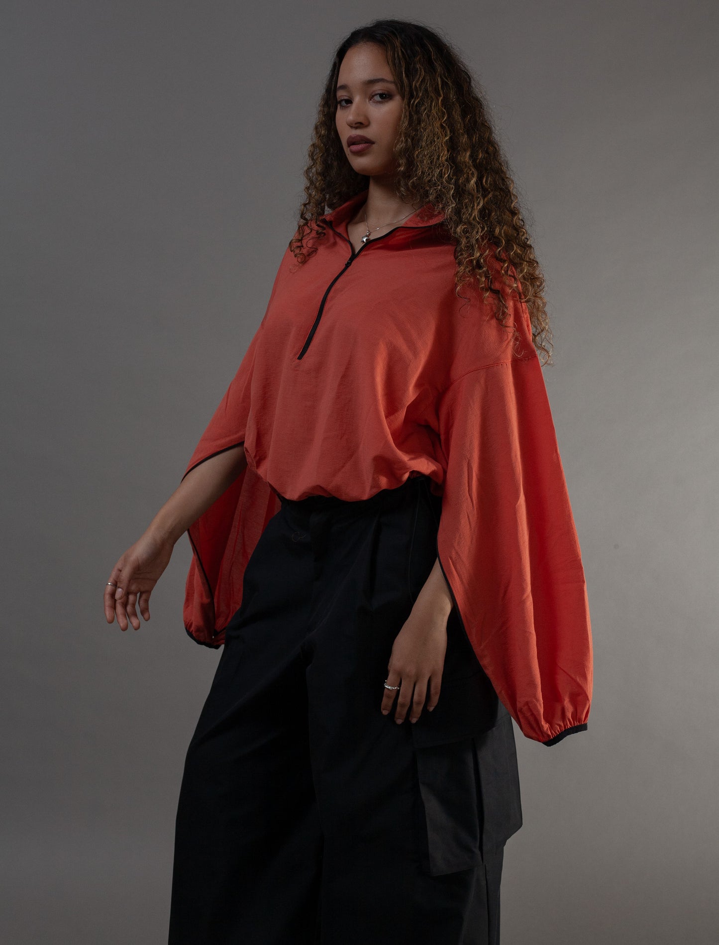hands through sleeves orange Asia top