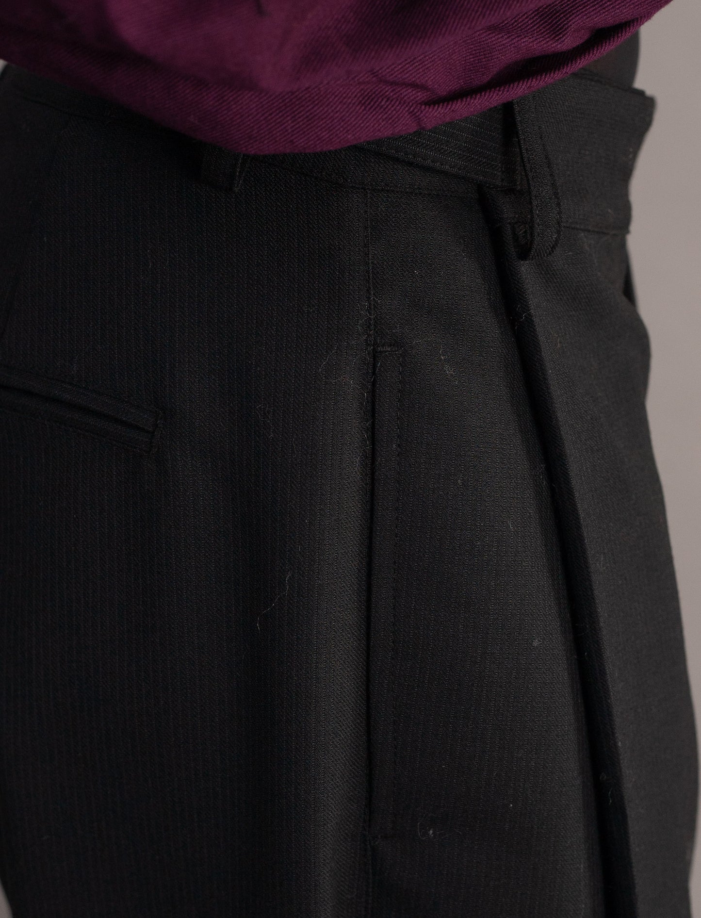 Close-up of dark grey pinstripe pants 