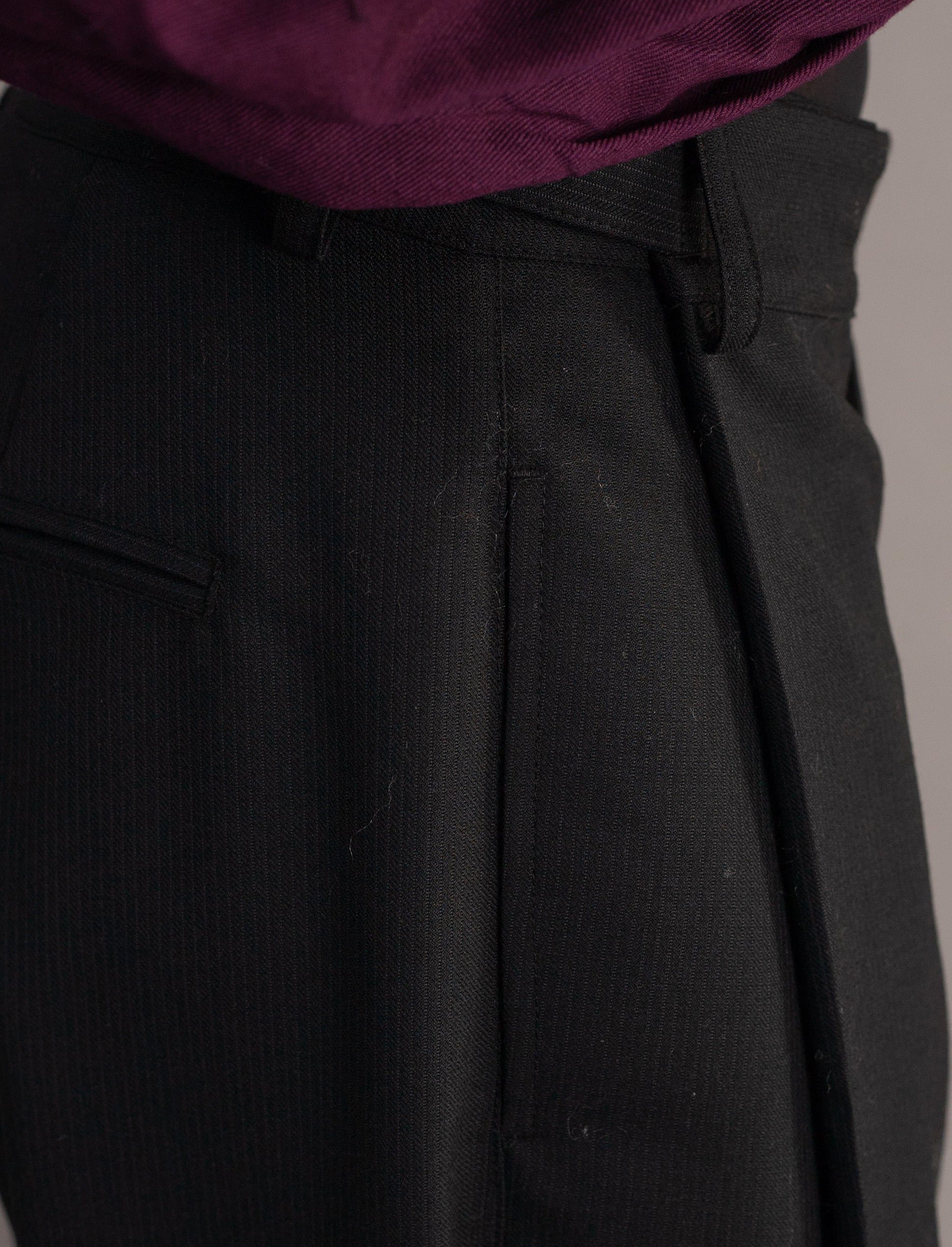 Close-up of dark grey pinstripe pants 