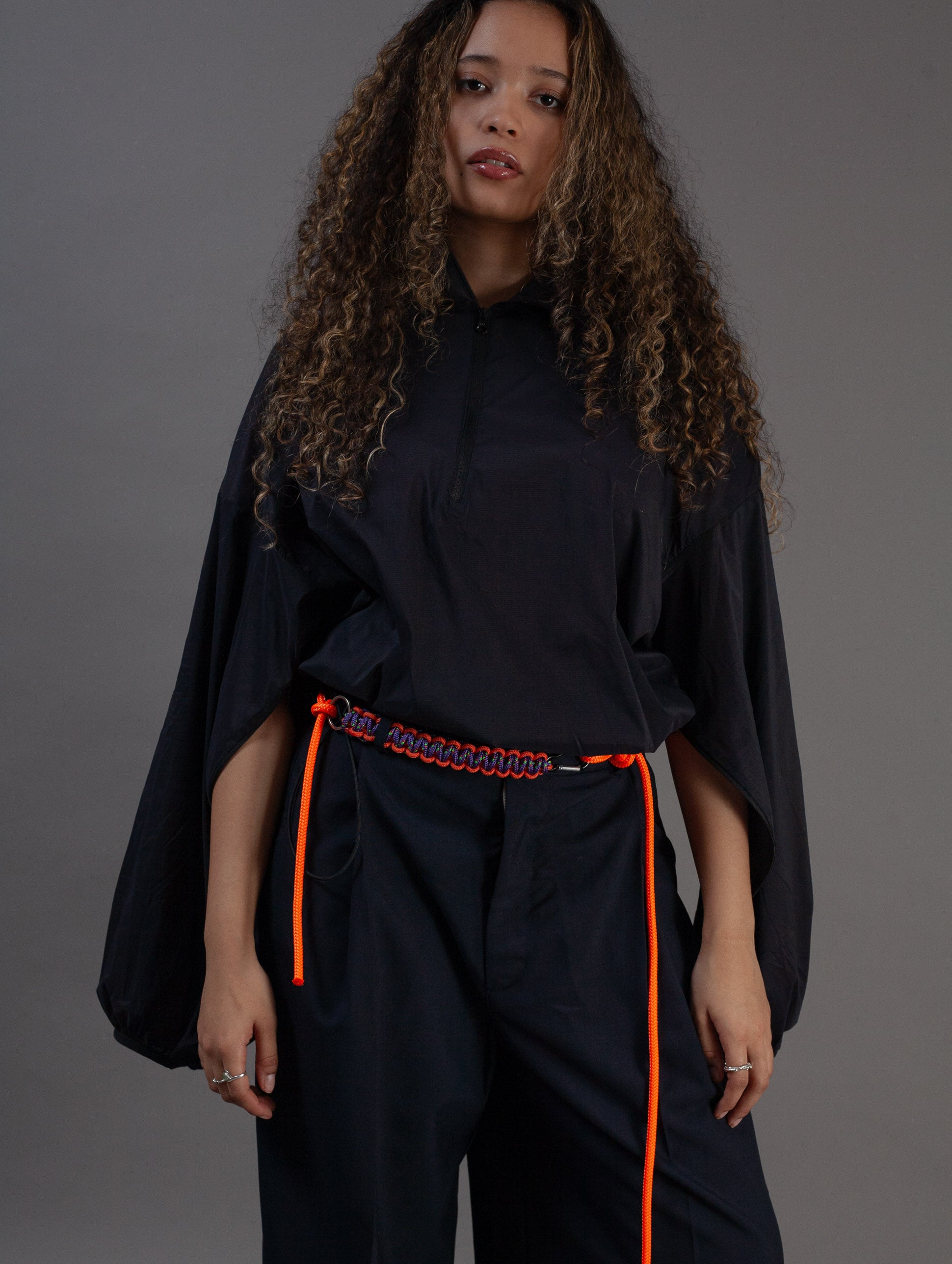 black Asia top front view with hands through sleeves