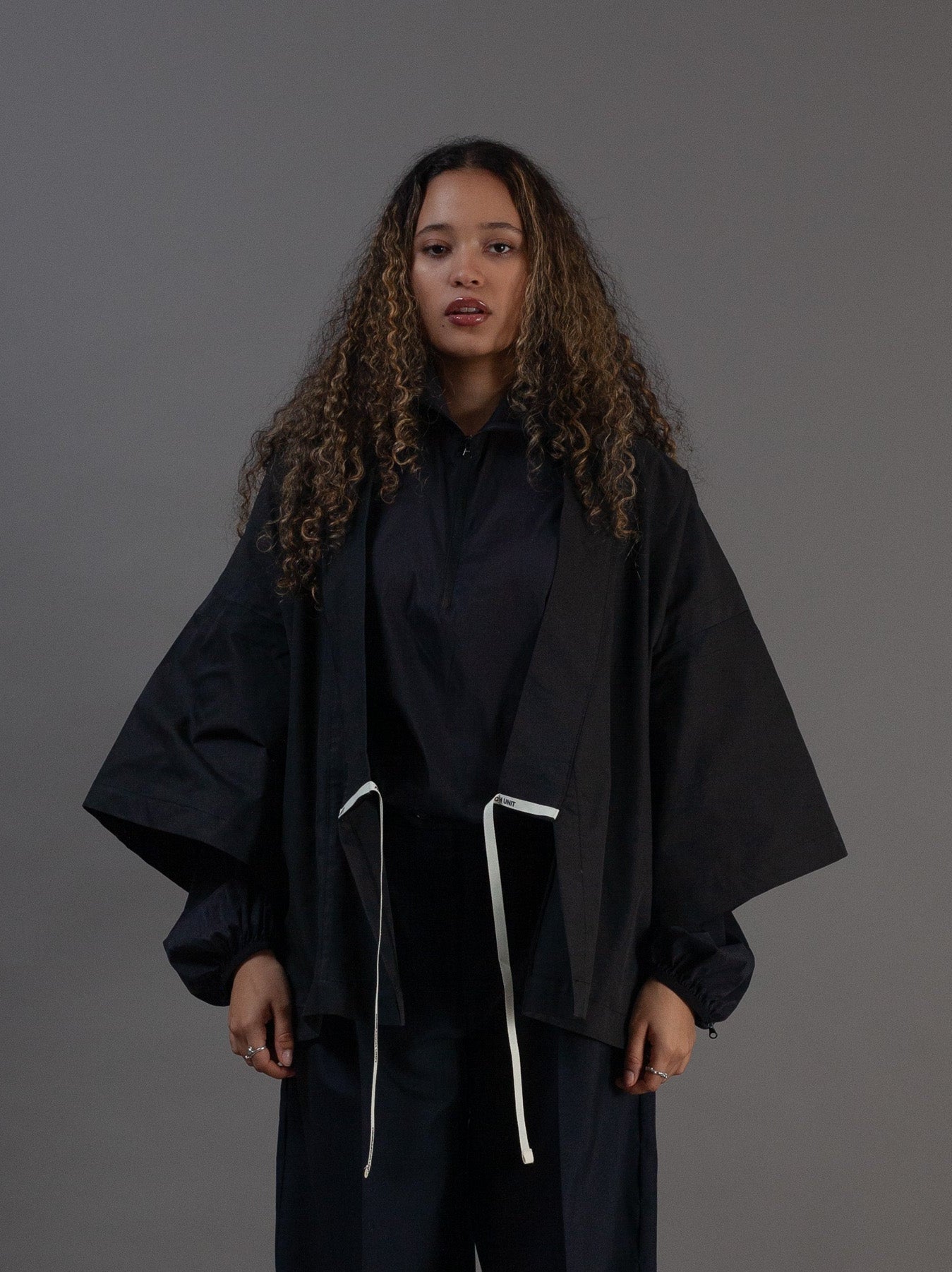 Person wearing a black kimono with white drawstrings 