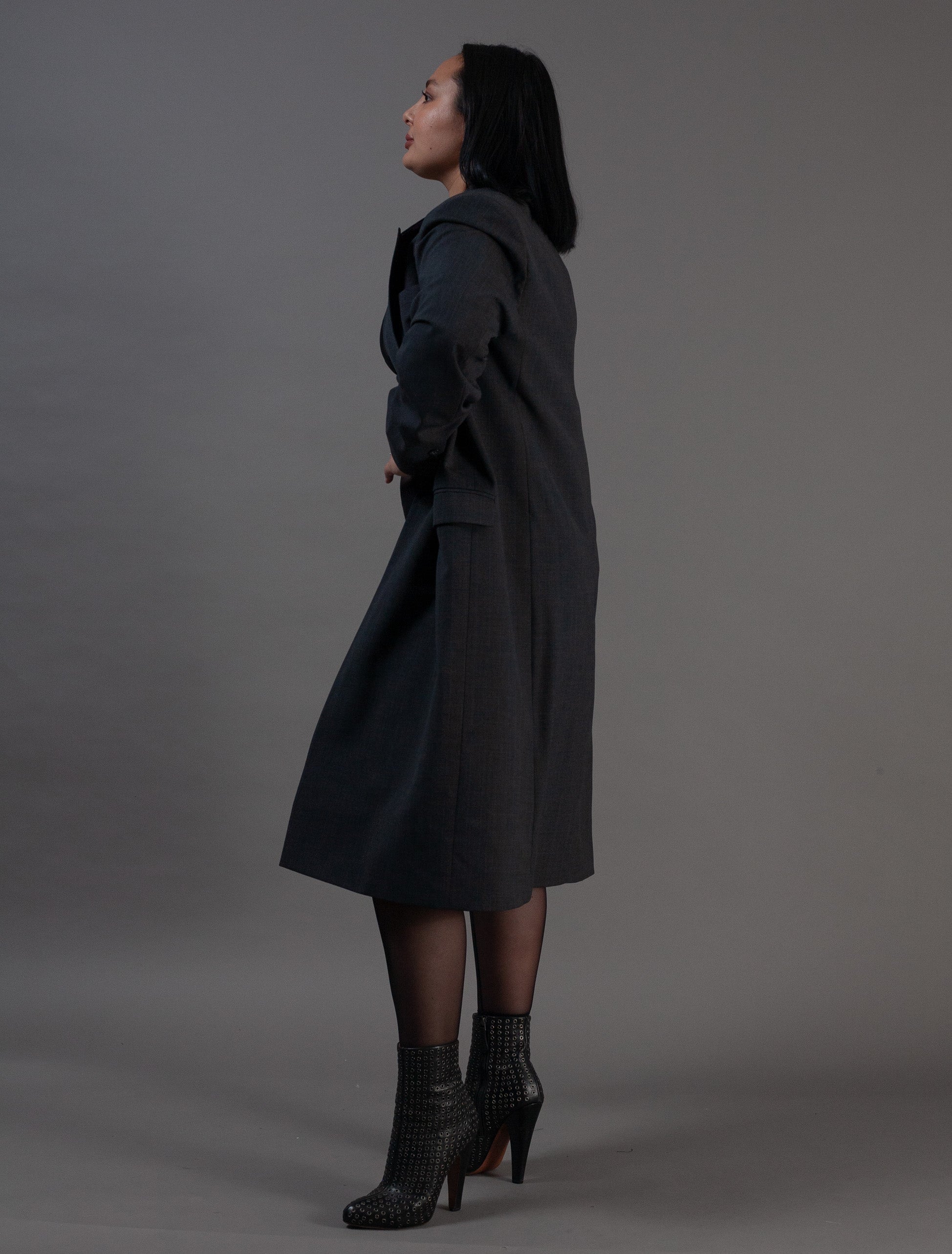 Woman wearing a long grey pinstripe coat 