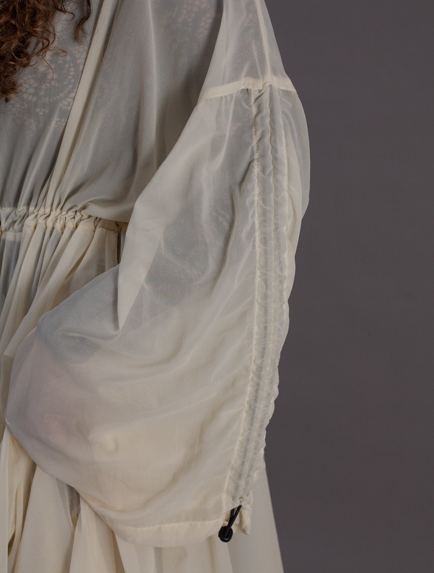 Close-up of a sheer cream chiffon dress