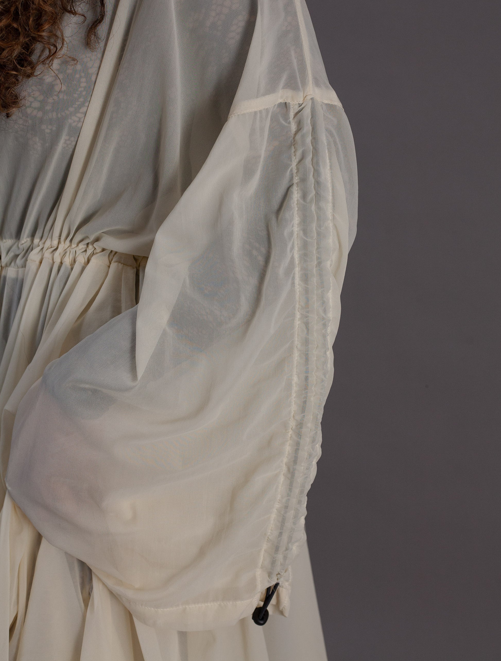 Close-up of a sheer cream chiffon dress
